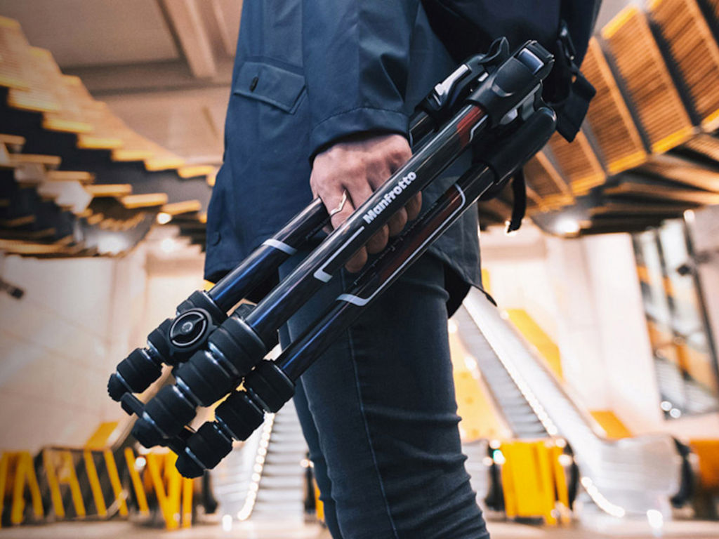 A photo of a photographer with a Manfrotto tripod
