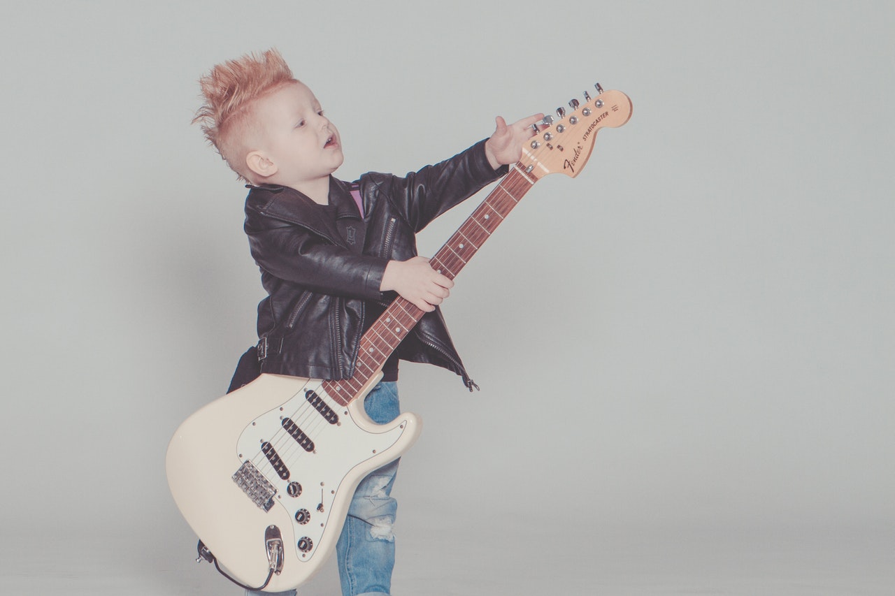 Child playing electric guitar