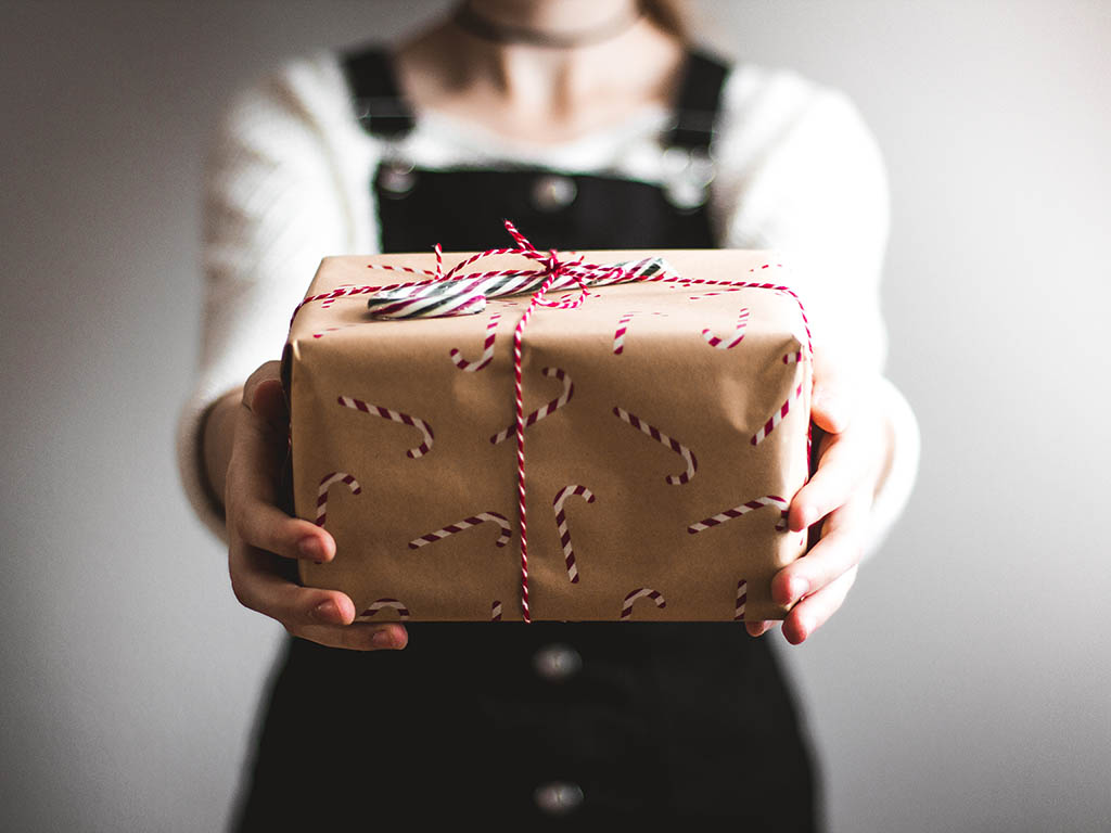 A photo of a person holding a Christmas gift
