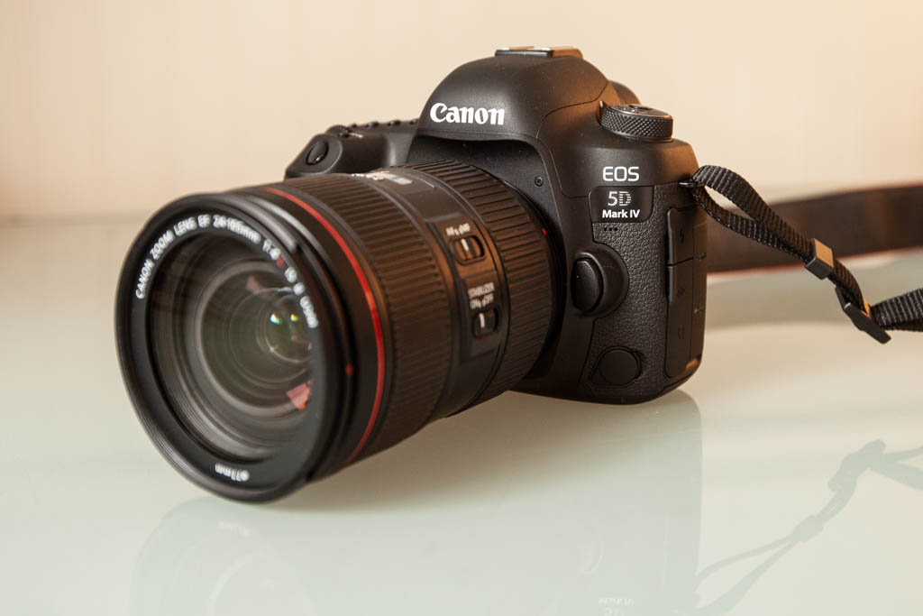 A photo of the Canon 5D MkIV DSLR camera sitting on a glass table
