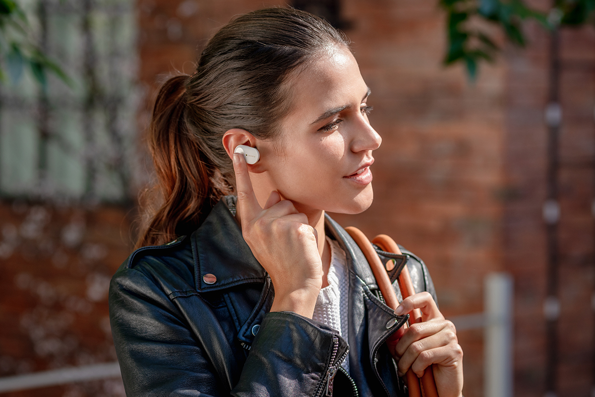 image of woman taking a phone call with the Sony 1000XM3 headphones