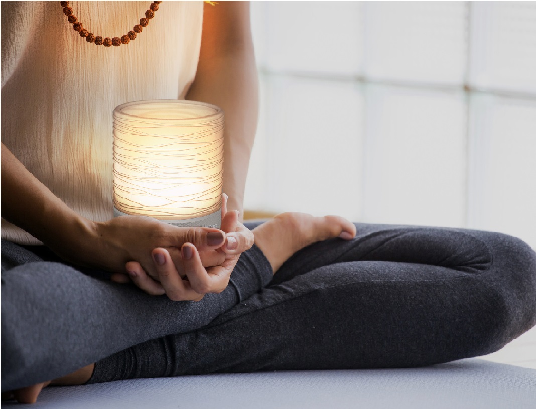 image of woman holding light therapy lamp device