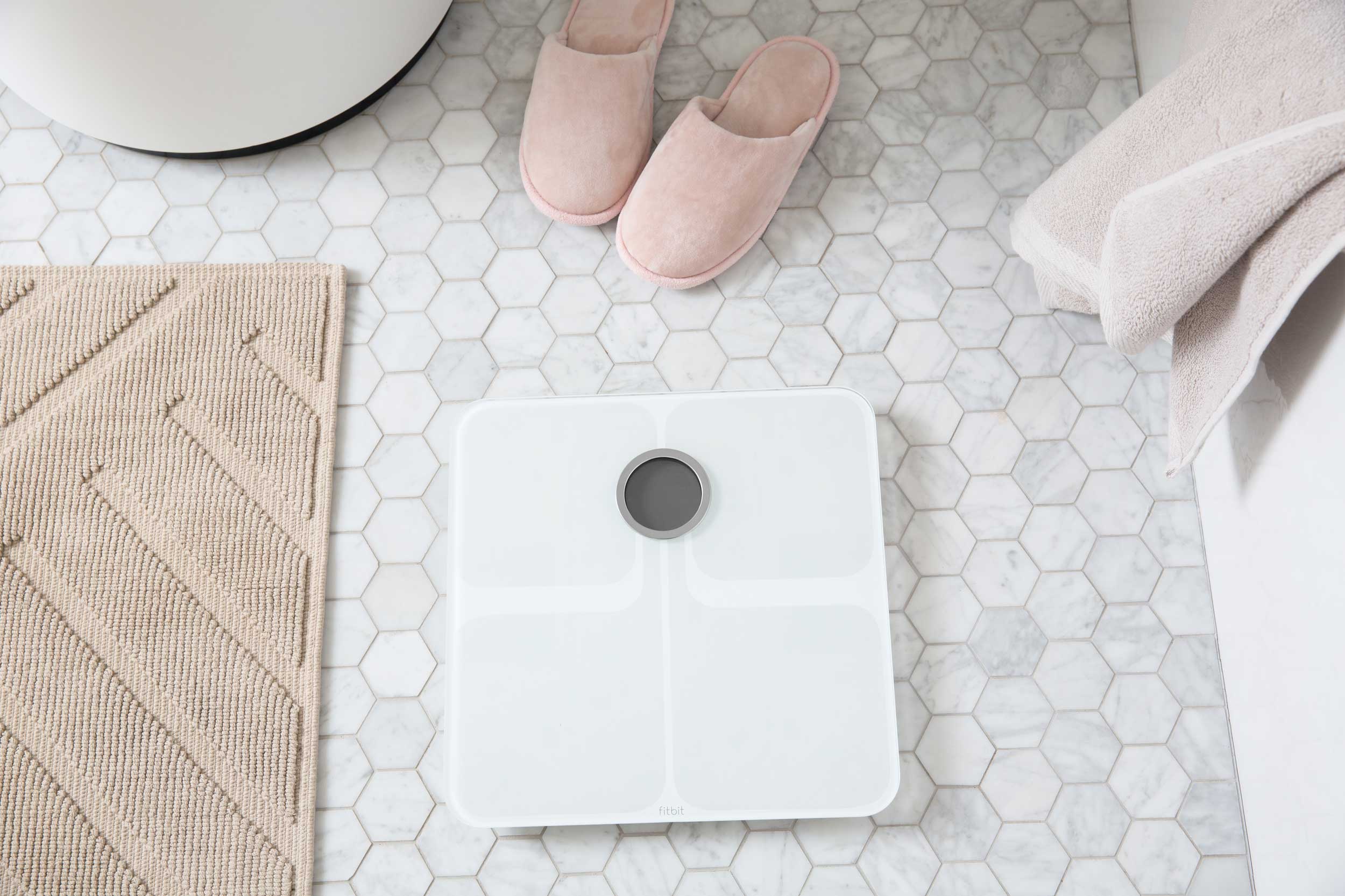 Fitbit Aria smart scale on kitchen tiles