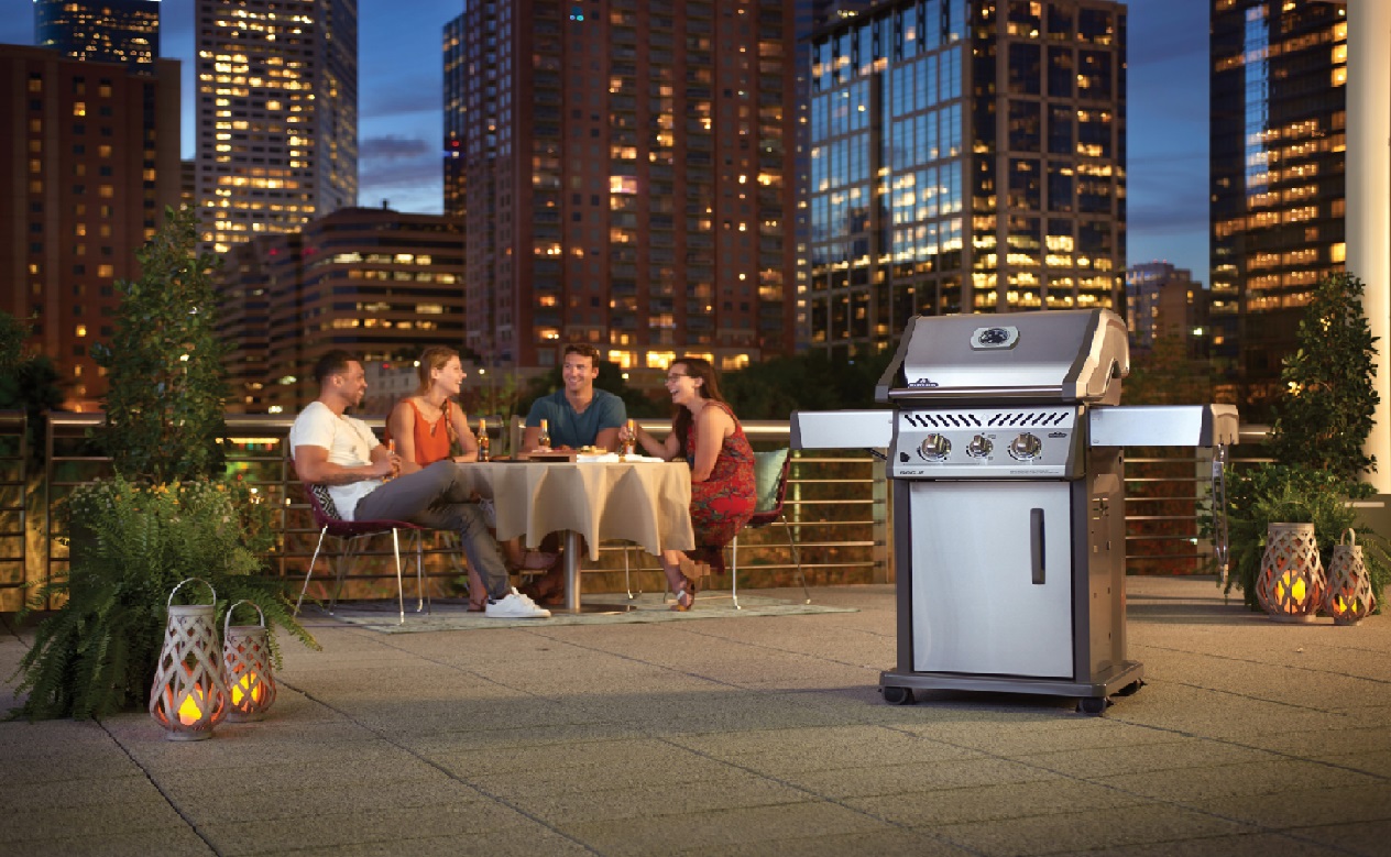 image of a rooftop BBQ party with a BBQ in the foreground