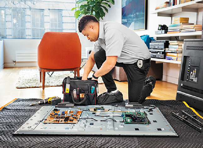 image of a Geek Squad Agent kneeling with a kit of tech tools