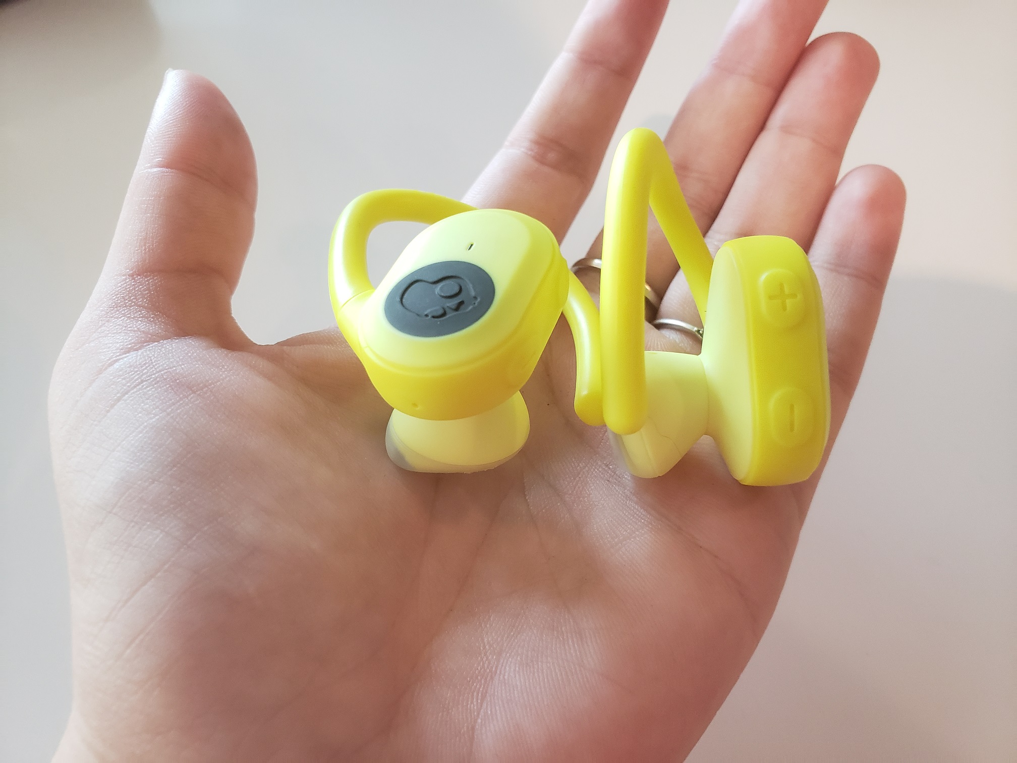 image of hand holding Skullcandy Push Ultra earbuds