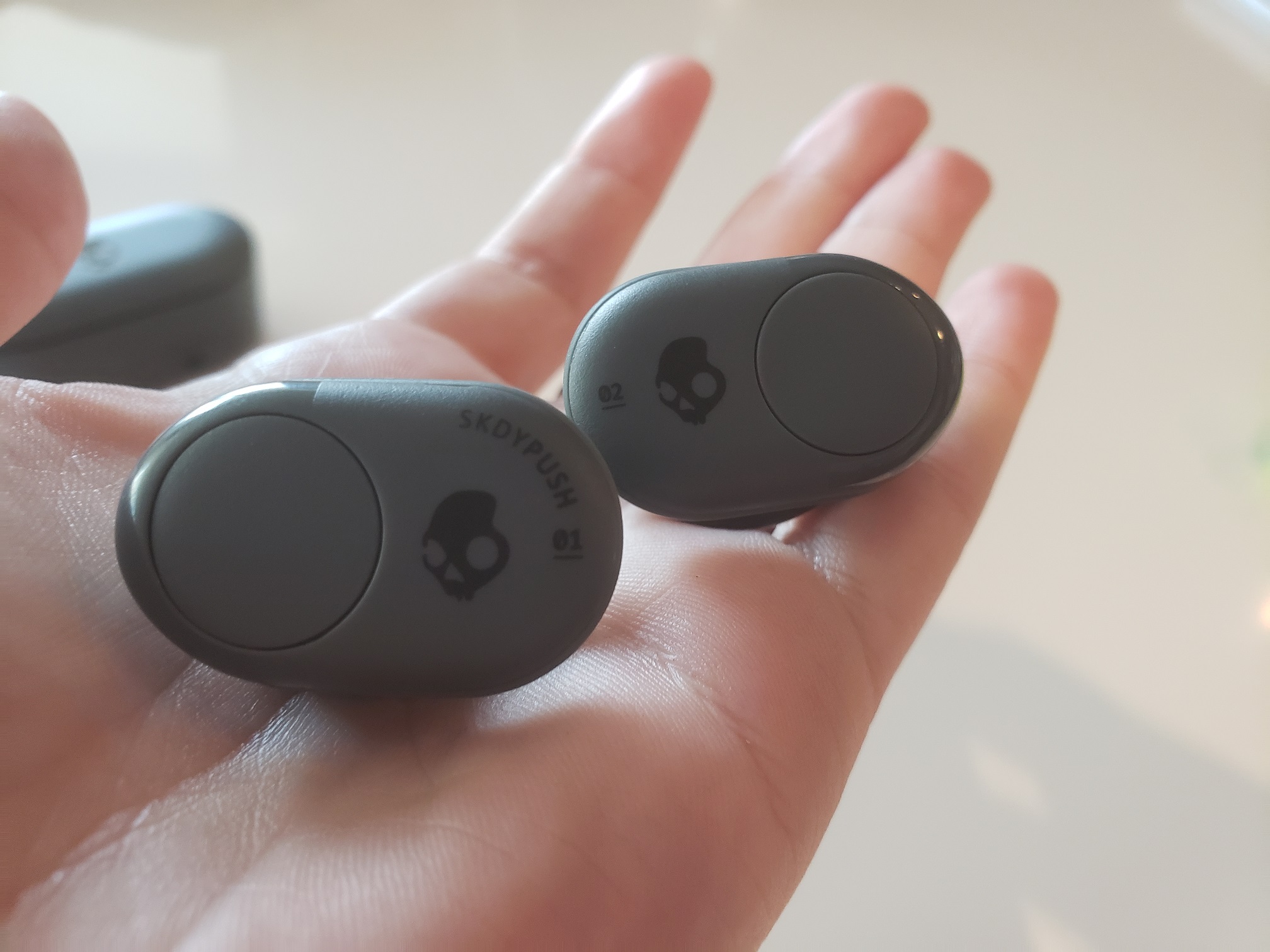 image of a hand holding Skullcandy Push earbuds