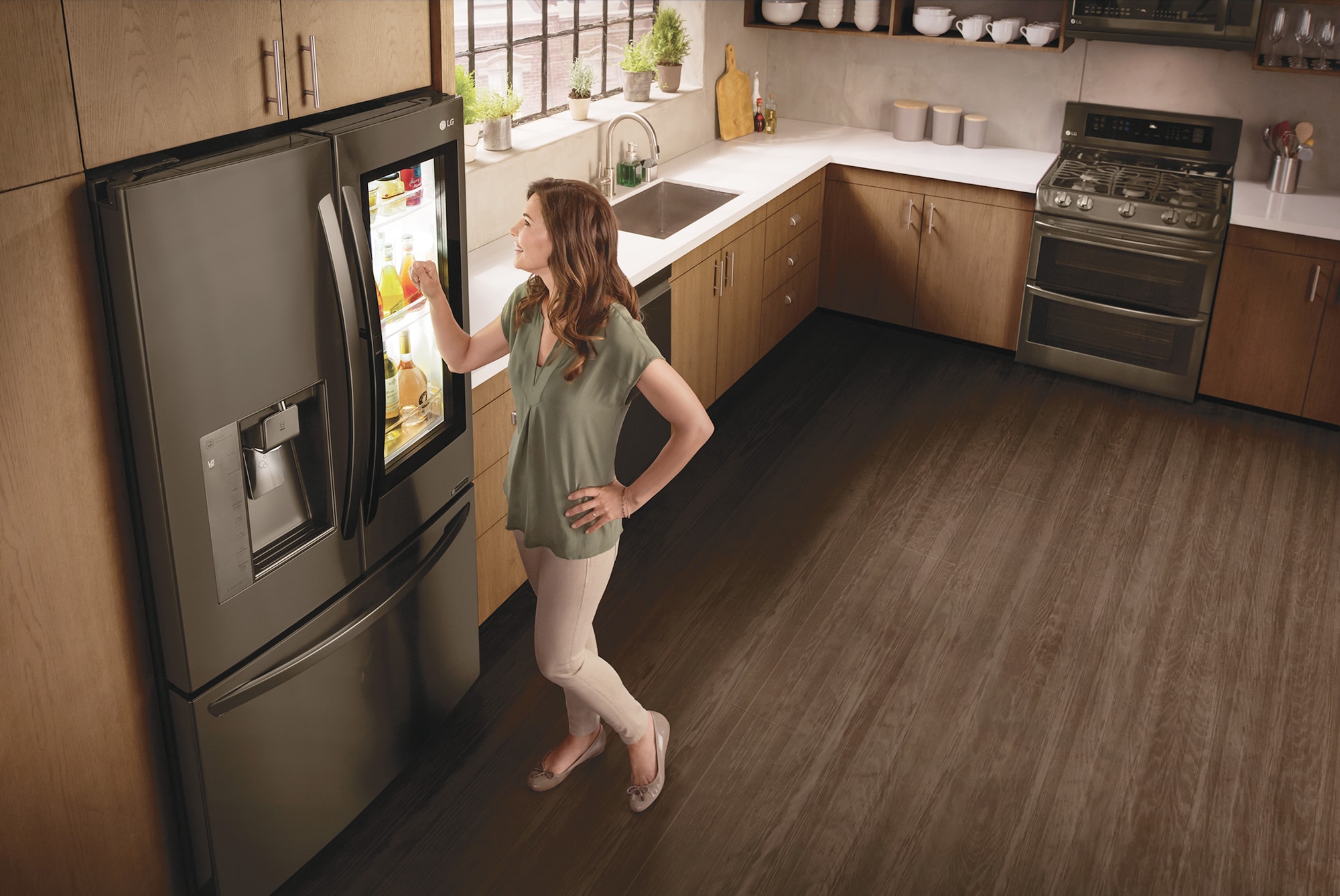 A woman standing by a smart refrigerator