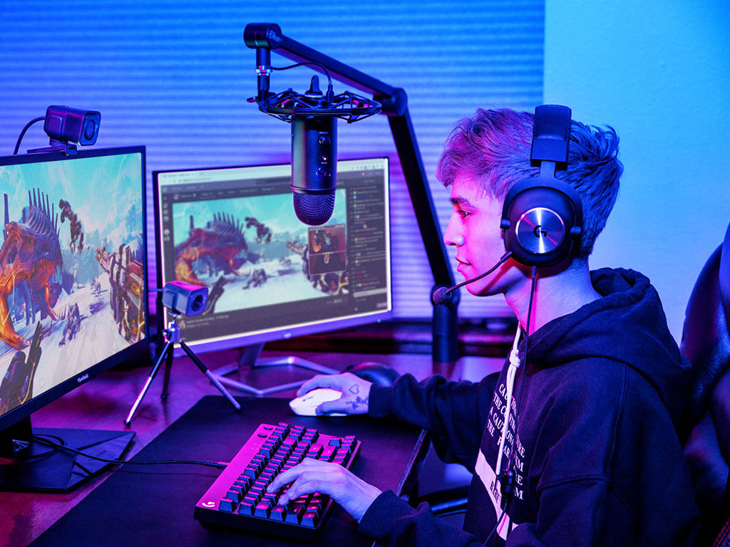 A gamer using a webcam to stream gameplsy