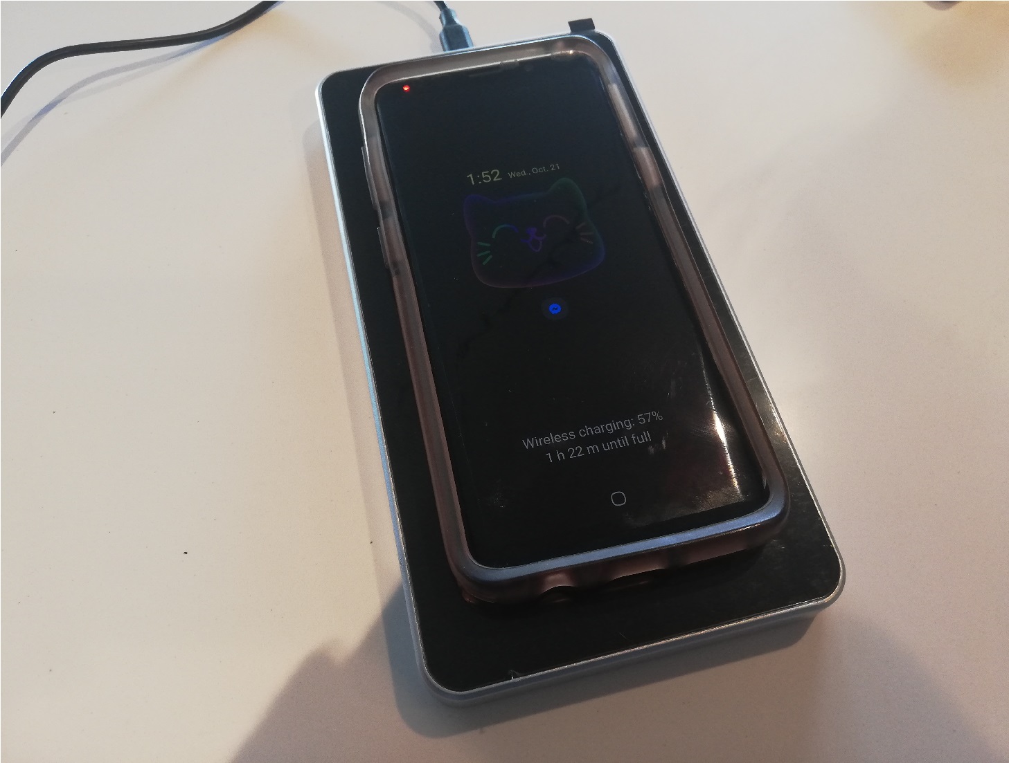 image of a phone charging on the wireless charging pad surface