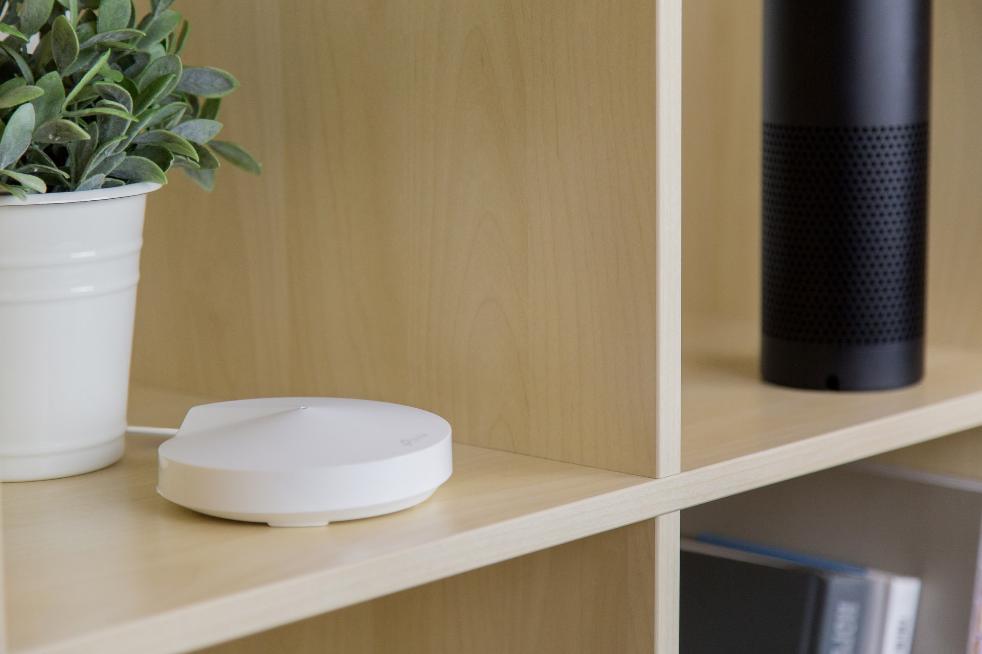 The TP-Link Deco M5 Mesh Router placed on a shelf