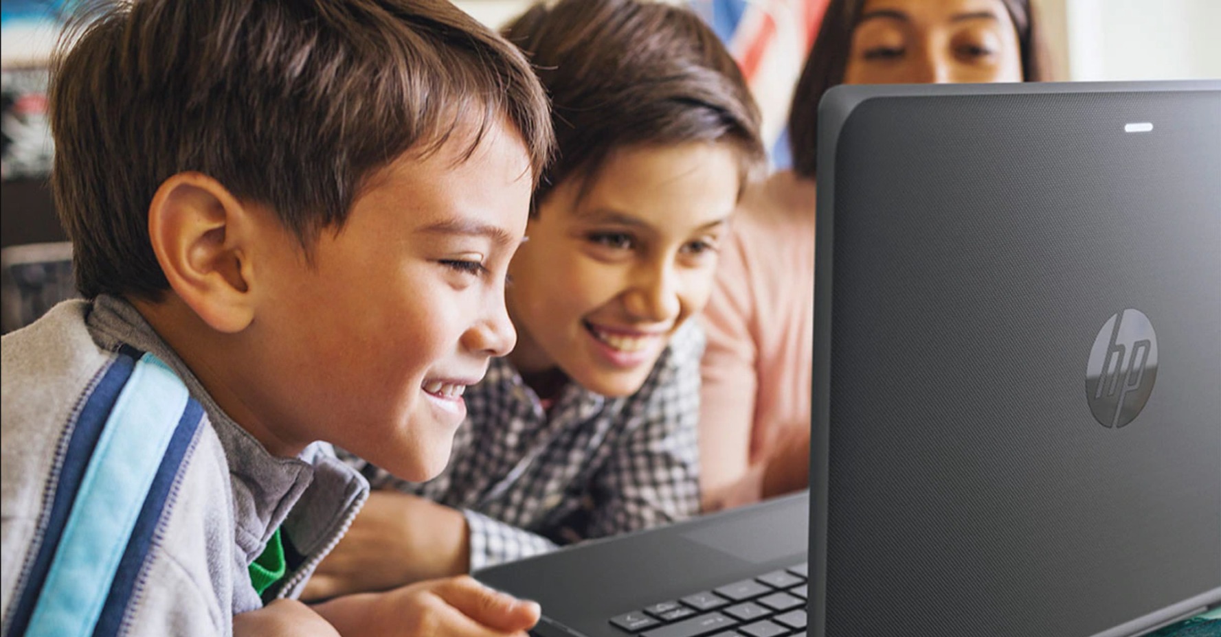 image of 2 boys looking at a laptop screen