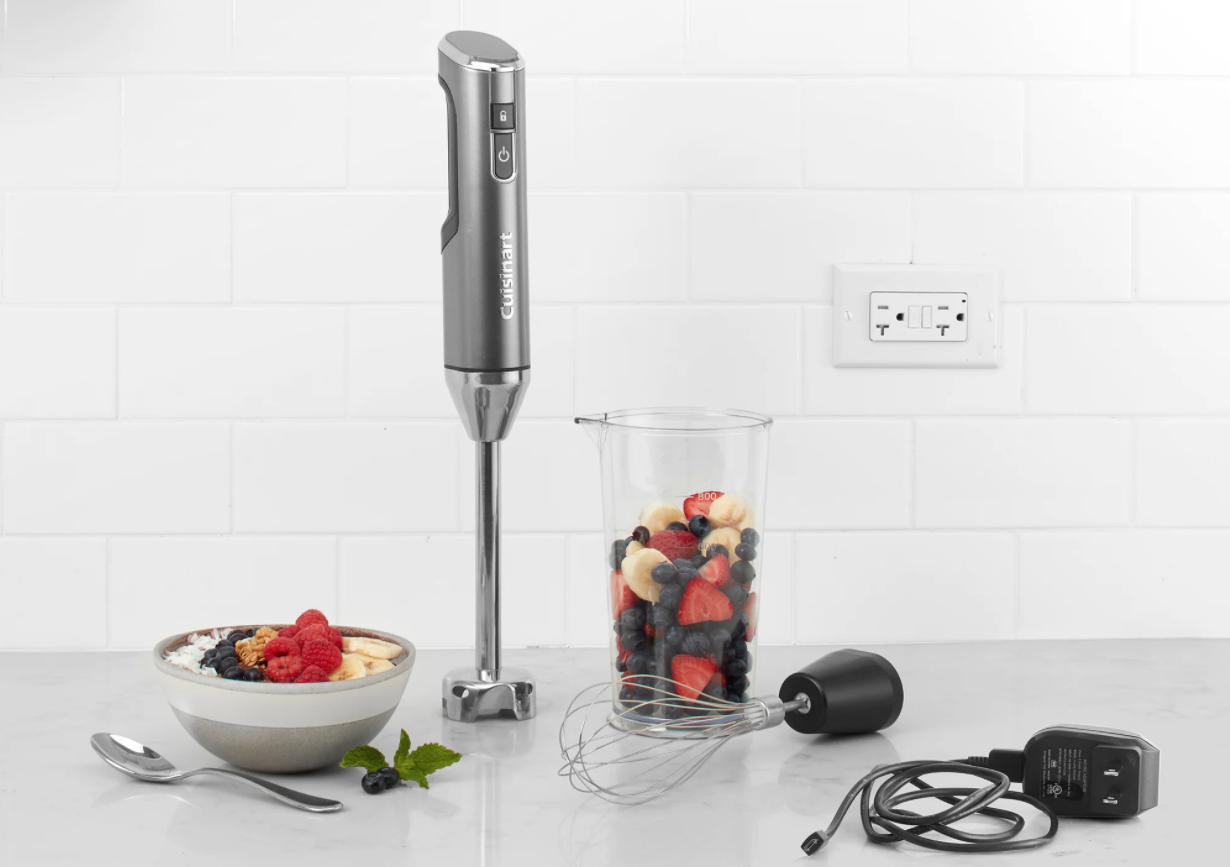 image of the Cuisinart Cordless Immersion blender with whisk attachment and cord nearby, and measuring beaker filled with fruit