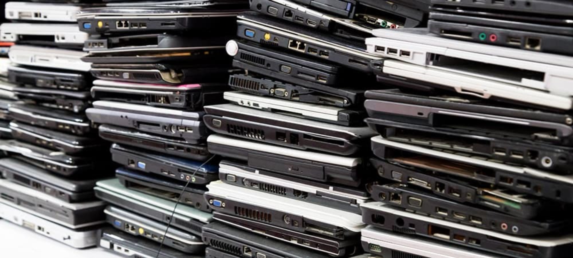 image of dozens of laptops stacked on top of each other