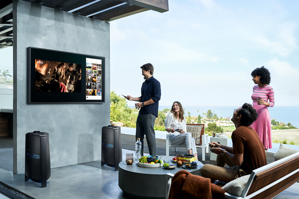 A family enjoying the Samsung The Terrace TV