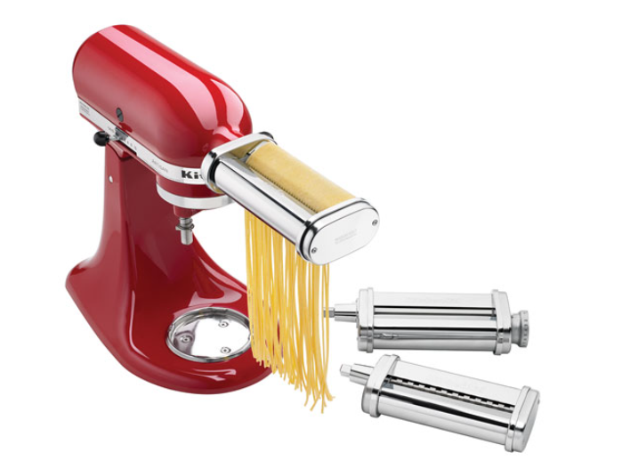 A KitchenAid stand mixer cutting fresh pasta with a pasta maker attachment