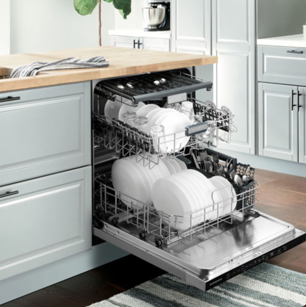Insignia 24-inch dishwasher installed and open with dishes.