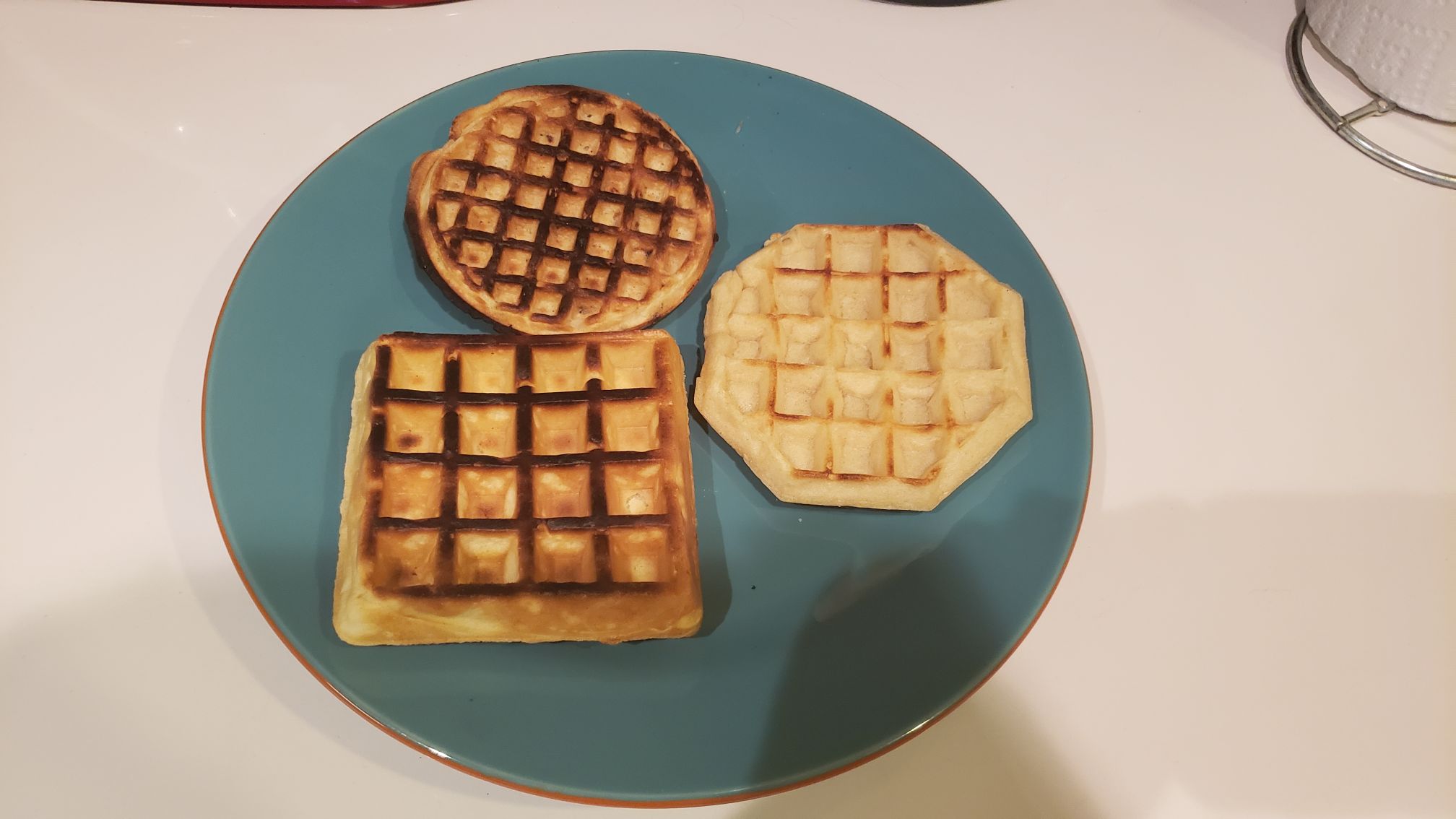 3 types of waffles on a plate, 2 of them are overcooked