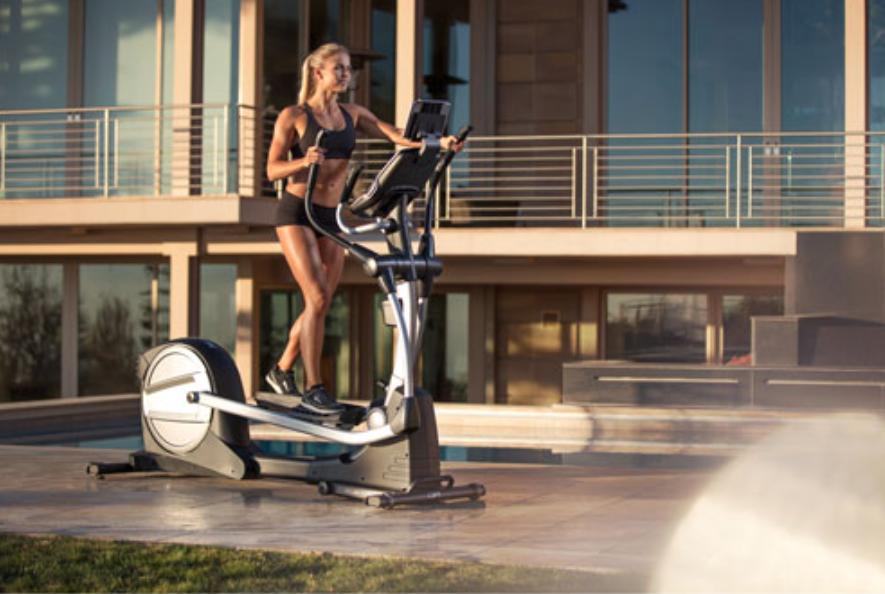 Woman outside on a Nordictrack Spacesaver elliptical machine.