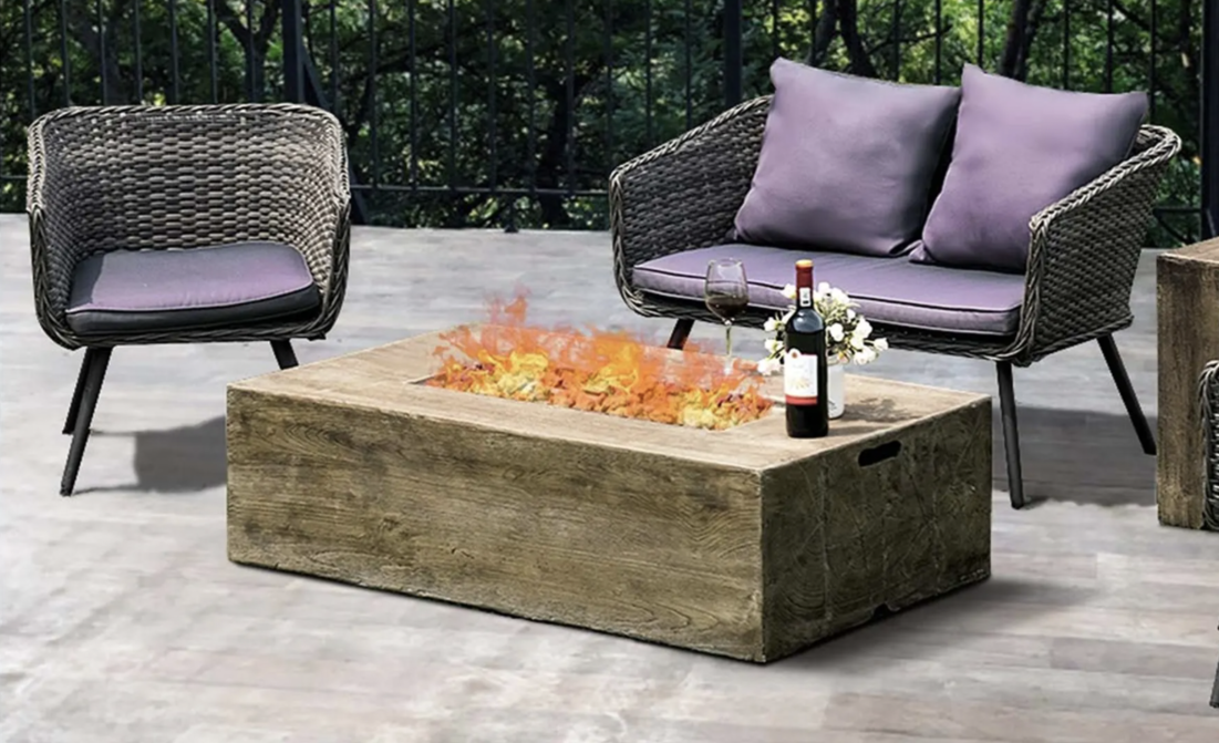an outdoor fire pit surrounded by patio furniture