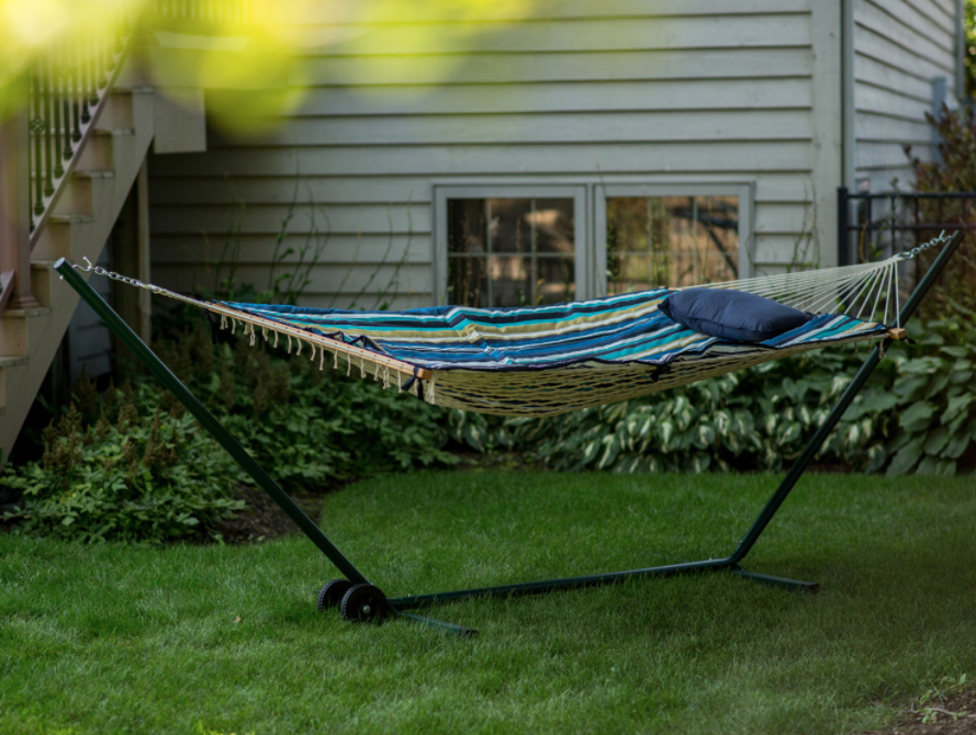 Hammock outdoors with built-in stand and wheels.