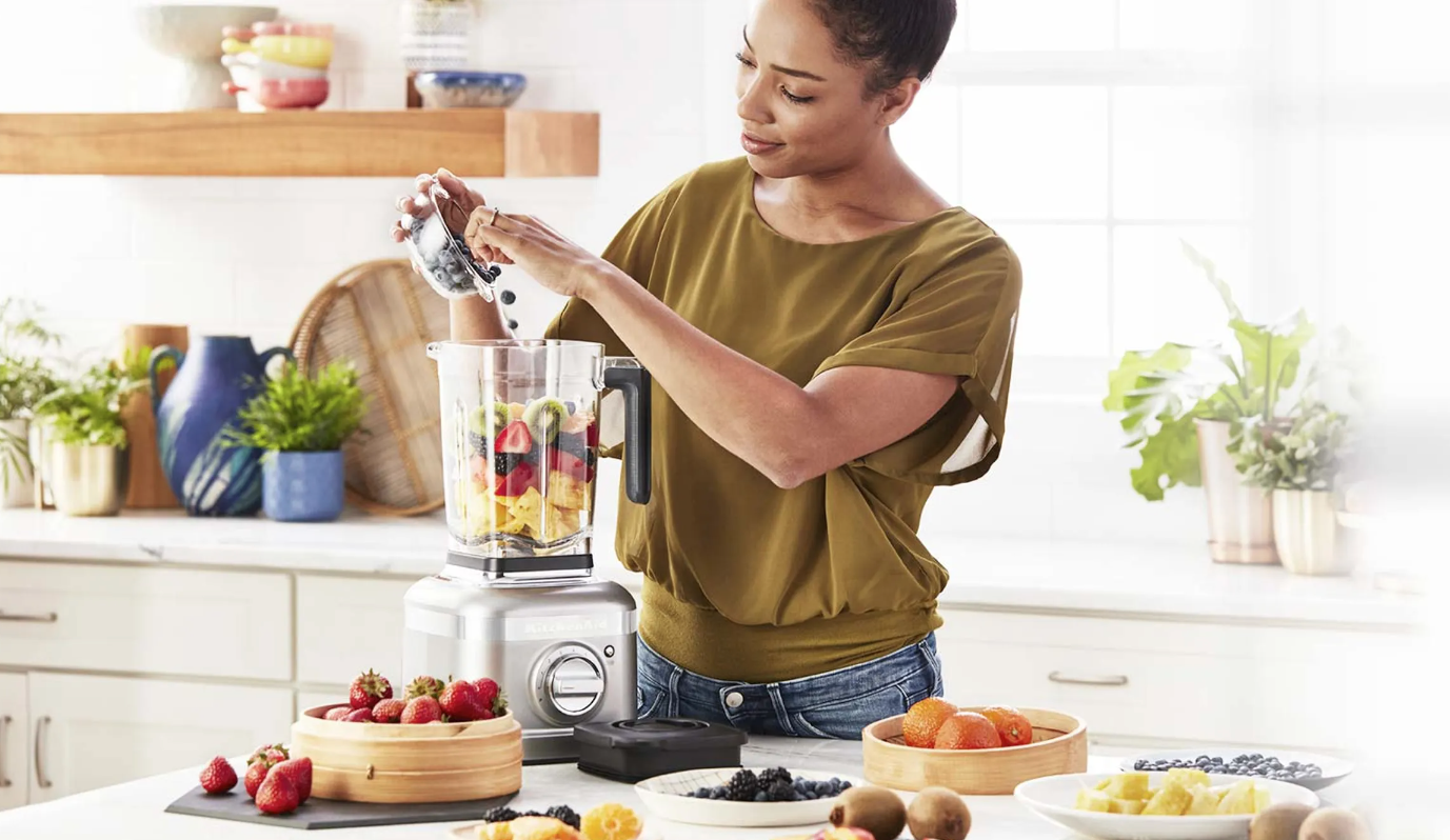A woman with a blender for keeping fit