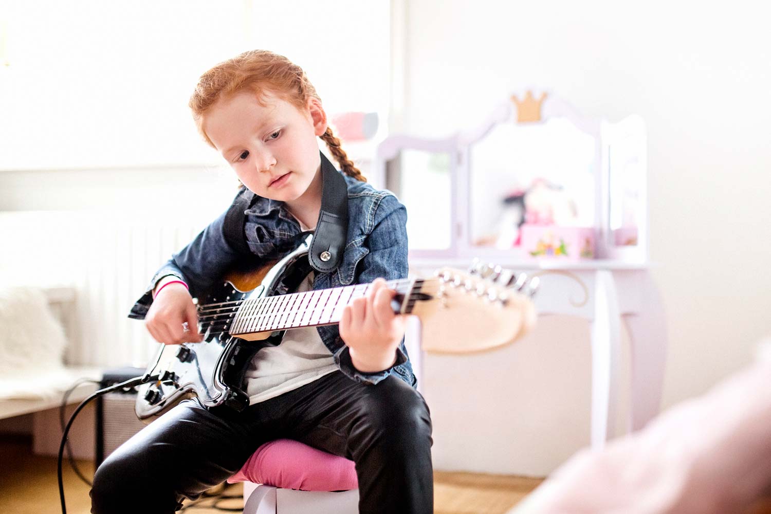 young girl playing guitar