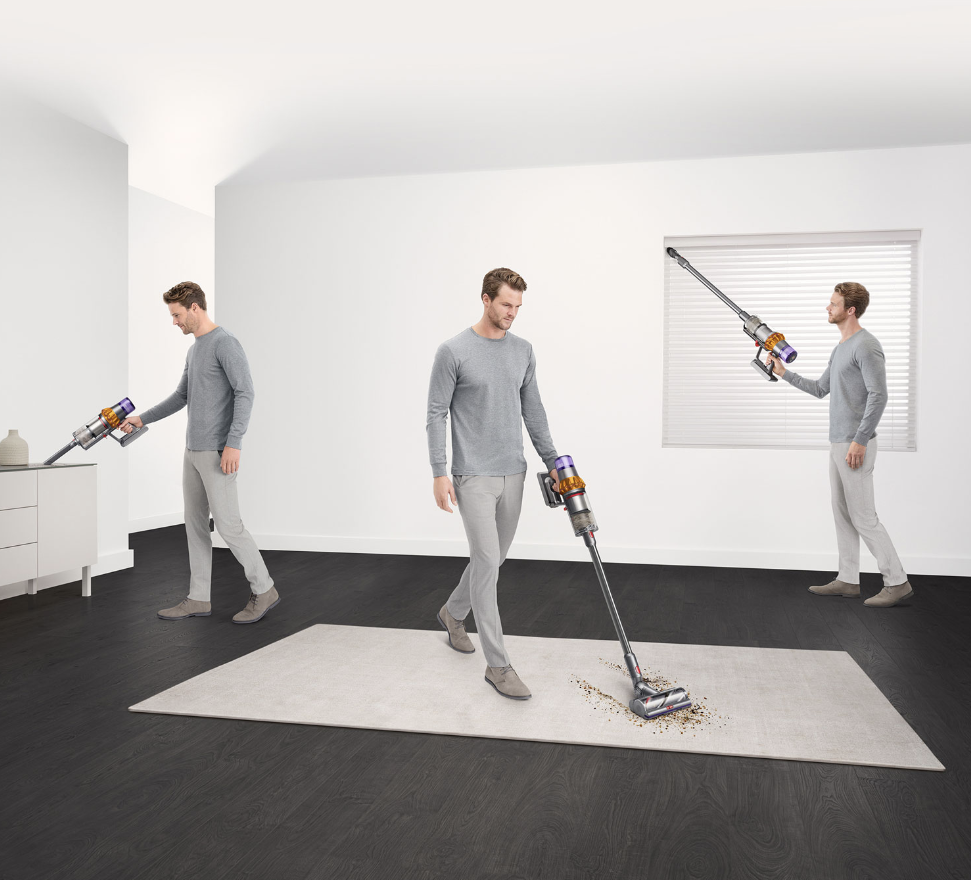 Man vacuuming with Dyson V15 Detect