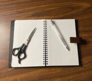 Pen and paper tools being illuminated by the bright white light of a Mobifoto ring light with little shadows