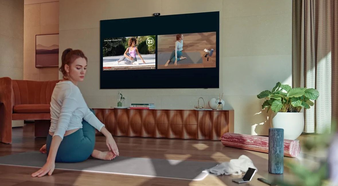 Samsung health TV on a smart TV with a woman using it to workout and view her posture while watching a workout routine online