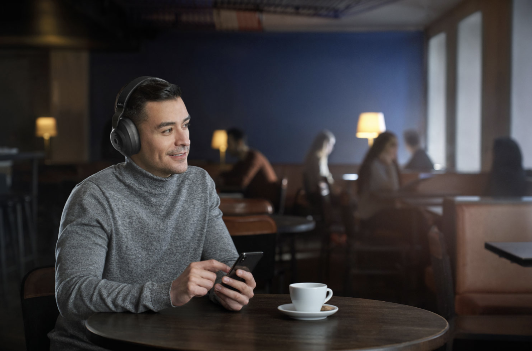 Man wearing Jabra Elite 85h noise cancelling headphones.