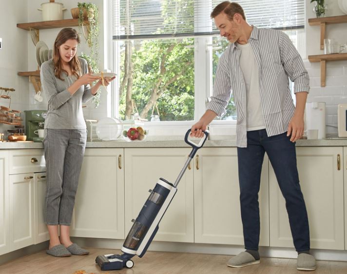 Couple using wet dry vacuum cleaner