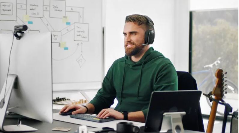Man working from home with headphones on 