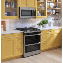 Yellow kitchen with an oven range that has its doors closed. 