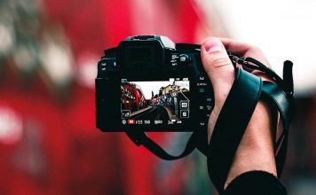 Photo of a person's hand holding a camera