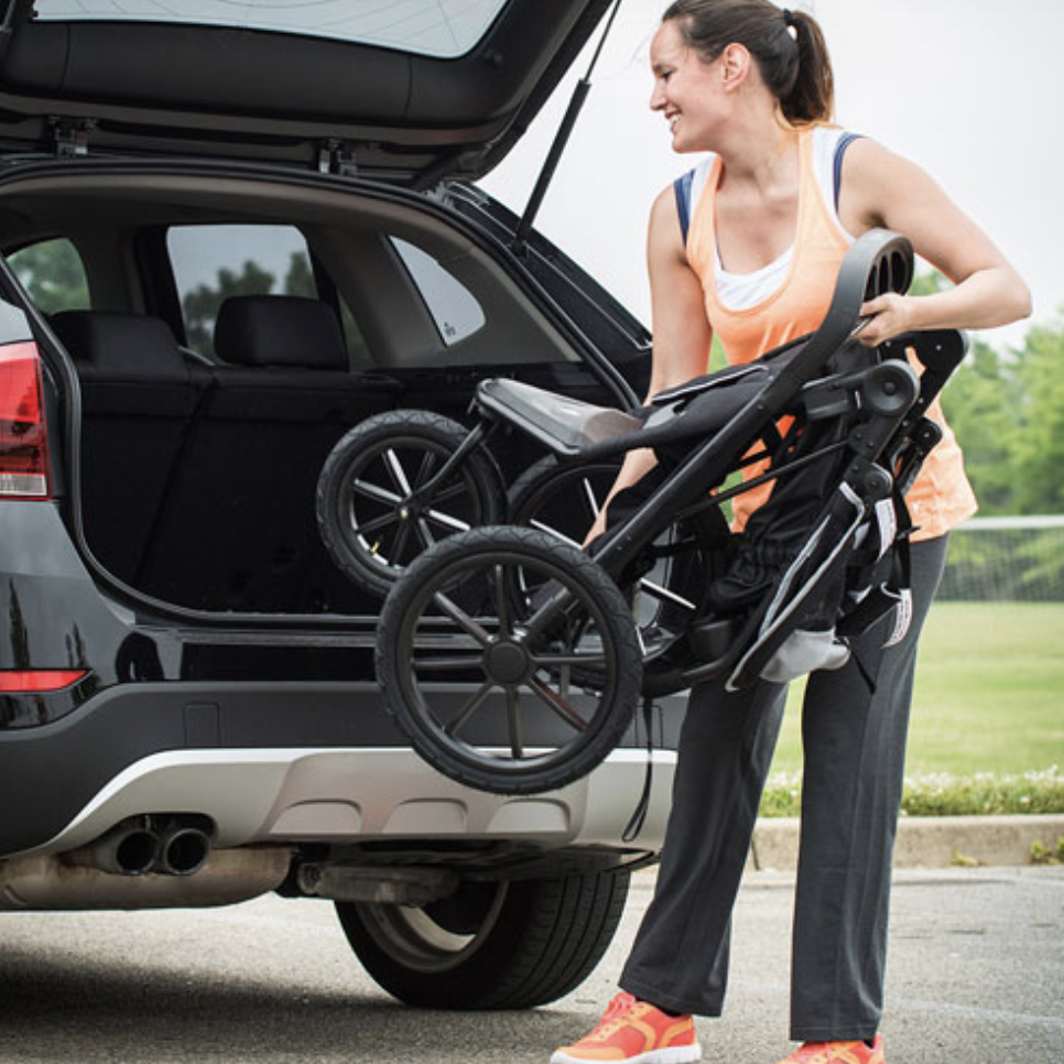 Woman putting a stroller in the trunk
