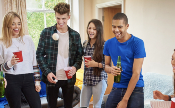 A group of friends playing beer pong.