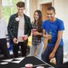 A group of friends playing beer pong.