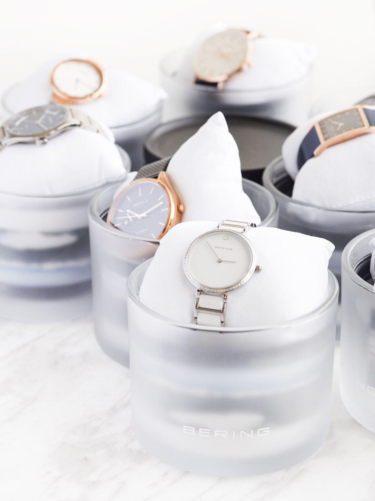 Bering watches in frosted glass case with pillows
