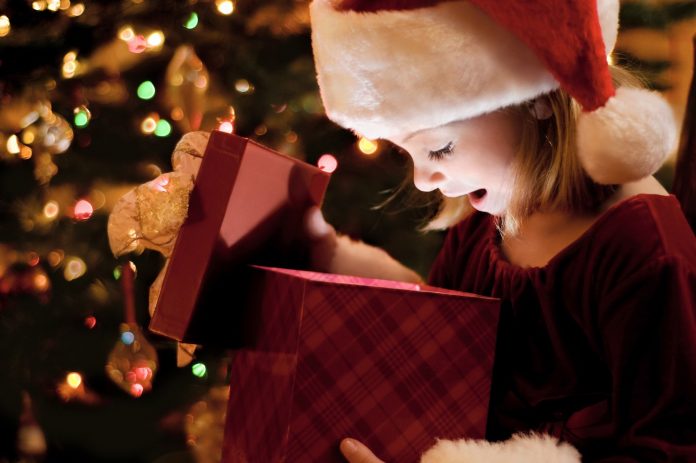 child opening christmas gift