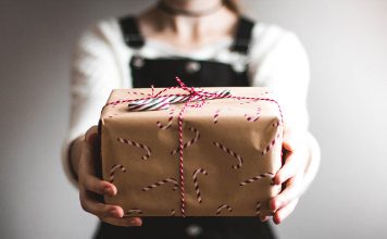 A photo of a person holding a Christmas gift