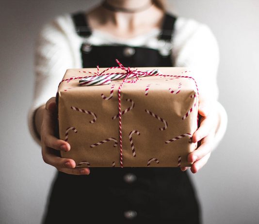 A photo of a person holding a Christmas gift