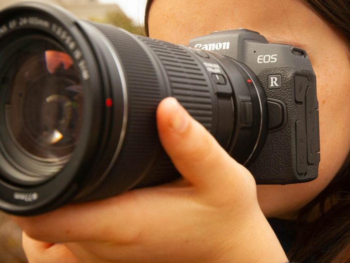 A girl taking a photo with the Canon EOS RP