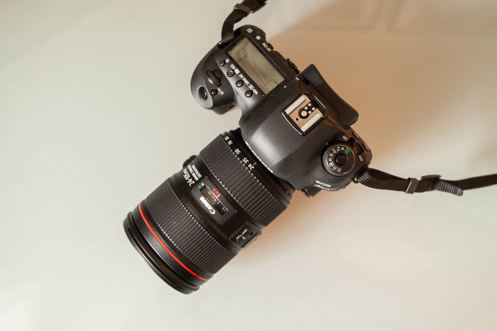 A top-down photo of the Canon 5D Mark IV sitting on a glass table