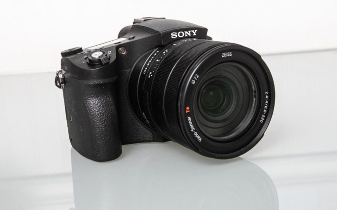 Photo of the Sony RX10 IV on a lgass table