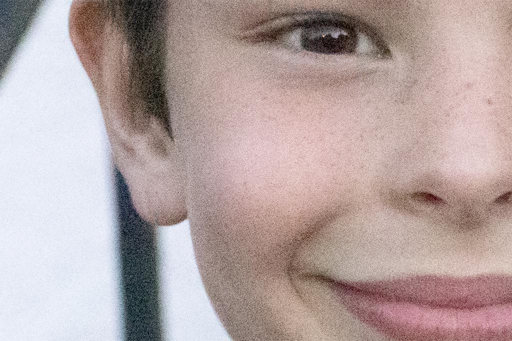 A close up crop of an image of a young boy taken with the Canon EOS 80D