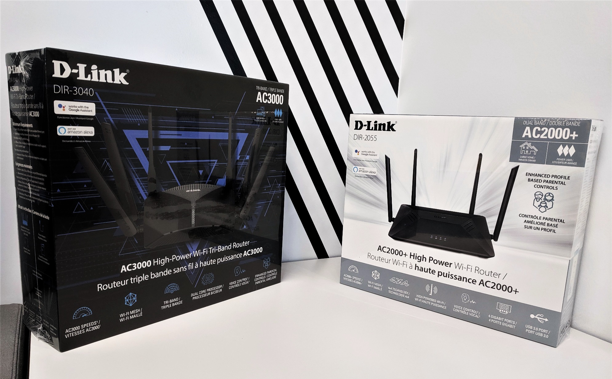 On the left is the D-Link AC3000 Wi-Fi router in its black box, on the right is the D-Link AC2000+ Wi-Fi router in its white box.