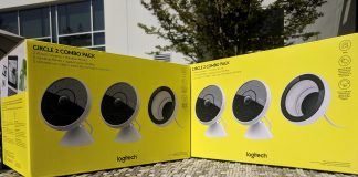 Two yellow Logitech Circle 2 boxes sitting on a table outdoors in the sun.