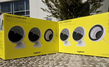 Two yellow Logitech Circle 2 boxes sitting on a table outdoors in the sun.