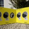 Two yellow Logitech Circle 2 boxes sitting on a table outdoors in the sun.